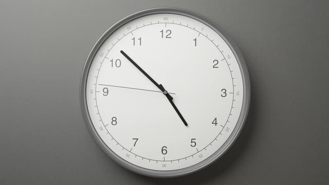 Clock Face on Dark Grey Office Wall in Timelapse