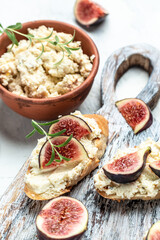 Fresh figs, cream cheese bruschetta on wooden table, Italian Bruschetta Menu, recipe, top view