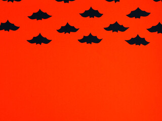 Dark blue silhouette of bats on orange. Background for Halloween party flyers. Place for your text.