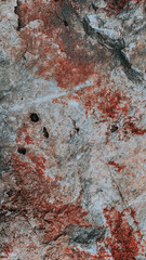 Vertical closeup shot of orange textured rough stone surface