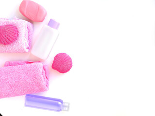 Spa set. Items on the left of the frame. Towel, soap, washcloth, care products, bath bombs in pink...