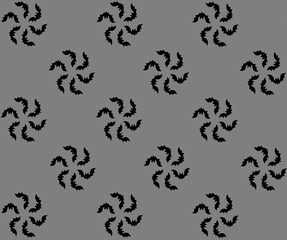 The silhouette of bats is assembled into a round flower. Seamless autumn pattern on gray background for Halloween. Gift wrapping paper for Halloween. Halloween textiles.