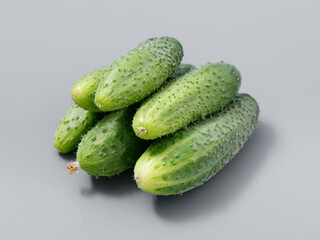 agricultural products green prickly cucumber on gray background