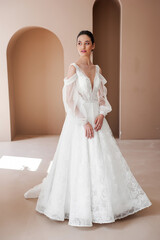 Fototapeta premium Smiling young woman posing in a wedding dress