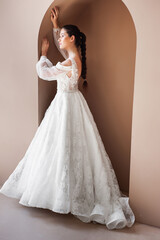 Fototapeta premium Smiling young woman posing in a wedding dress