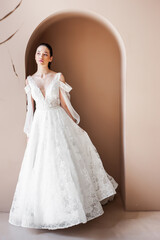 Fototapeta premium Smiling young woman posing in a wedding dress
