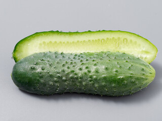 agricultural products green prickly cucumber on gray background