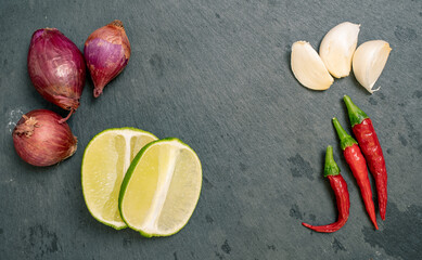 Shallot, Lime, Garlic and Chilli Peppers on Black Slate Tile