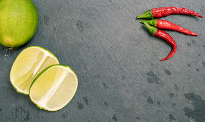 Lime and Chilli Peppers on Black Slate Tile