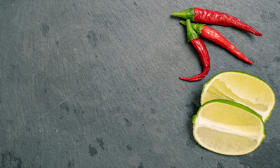 Lime and Chilli Peppers on Black Slate Tile