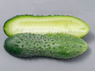 agricultural products green prickly cucumber on gray background