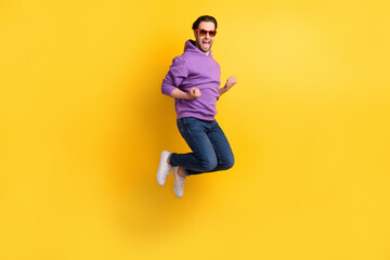 Fototapeta na wymiar Full size profile side photo of young man happy positive smile rejoice victory jump isolated over yellow color background