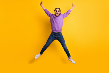 Fototapeta na wymiar Full body photo of young excited man happy positive smile jumper cool active isolated over yellow color background