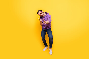 Fototapeta na wymiar Full body photo of young man happy positive smile have fun point fingers you choice isolated over yellow color background