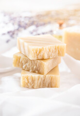 Natural handmade soap with lavender flowers on white silk. Aromatic natural soap. Organic soap.