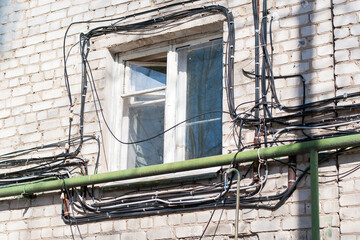 Electrical cables on the wall of the house.