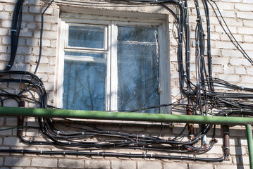 Electrical cables on the wall of the house.