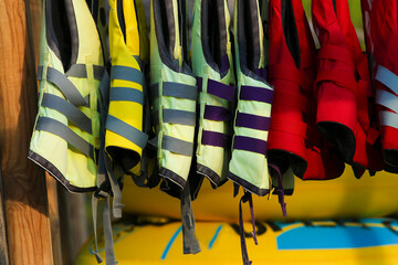 Group of red and yellow life vest in beach