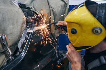 Welder using machine for welding a joint on auto surface