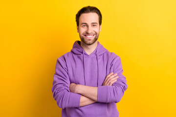 Photo of young cheerful man happy positive smile folded hands glad isolated over yellow color background