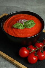 Gazpacho soup and ingredients on gray textured background