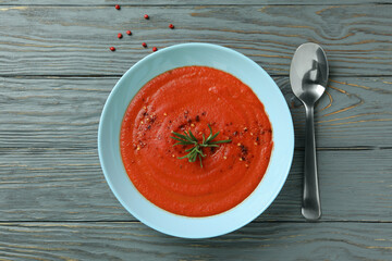 Concept of tasty eating with Gazpacho soup on gray wooden background