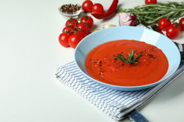Gazpacho soup and ingredients on white background