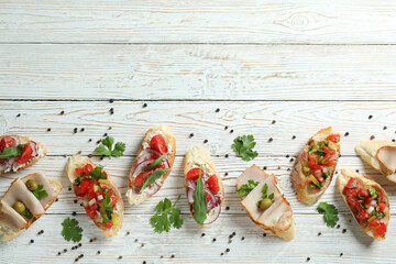 Delicious italian snacks bruschetta on white wooden background
