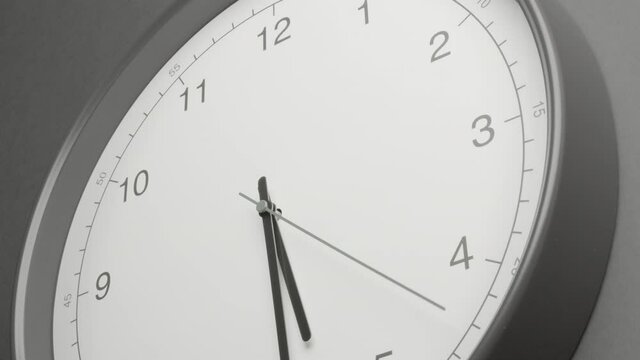 Clock Face on Dark Grey Office Wall in Timelapse