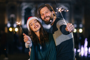 cheerful couple outdoors in winter waiting for the celebration w