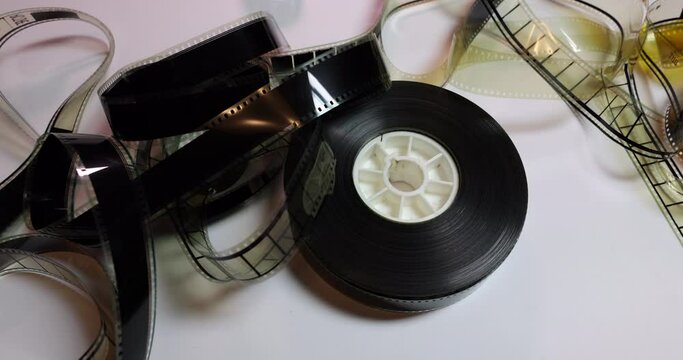 Side Tracking right to left on a film reel with some ruffled film clips