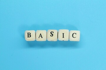 small wooden cubes with the word Basic