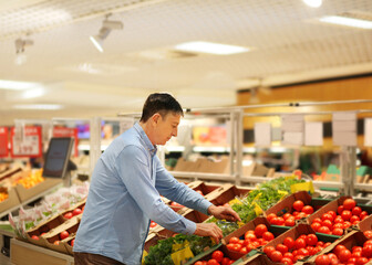 Senior Man Choosing  groceries, vegetables, fruits in the supermarket