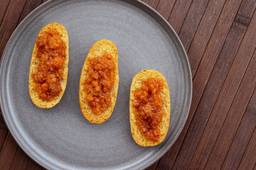 Cardamom rusks with cloludberry jam on gray plate