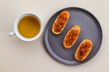 Cardamom rusks with cloudberry jam and cup of green tea