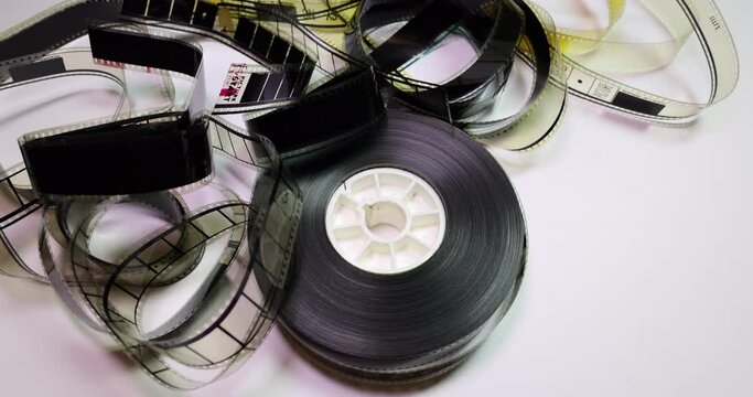 Circular Clockwise Pan on a film reel with some ruffled film clips