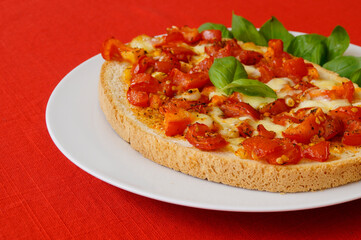 delicious large Italian bruschetta with mozzarella, garlic, olive oil and basil leaves on a plate