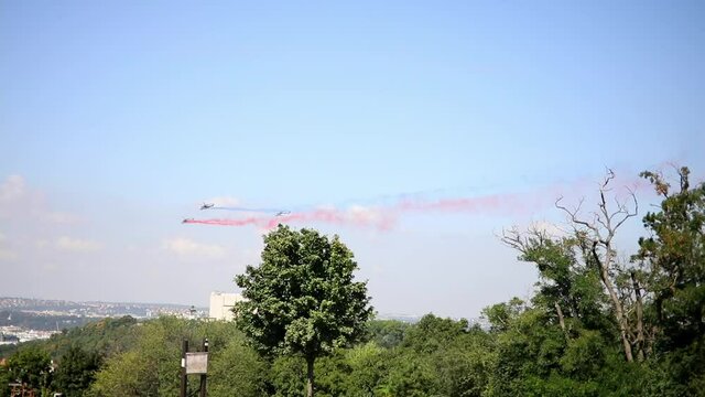 Combat helicopters leaving trails of red, blue and white colors behind in honor of the return of czech military from Afghanistan, Prague, Czech Republic