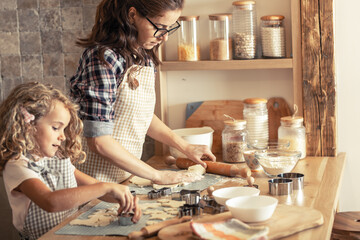 	
Mother and daughter playing in the kitchen and preparing dough to make cookies.Family concept.	
