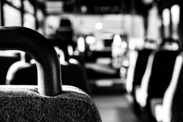 Focus on headrest of empty metro bus with the aisle to the front cleared © Lost_in_the_Midwest