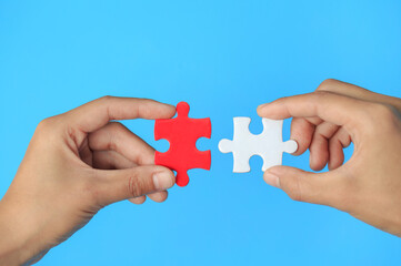 Closeup hand of man connecting jigsaw puzzle with sunlight effect, Business solutions, success and...