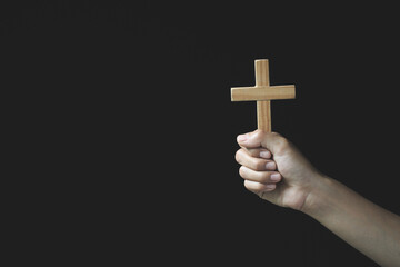 Human hand holds cross, Worship, sins and prayer, Religious concept. Eucharist Therapy Bless God...