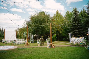 Wedding alley decorated with floral decorations, hanging lamps and a bar