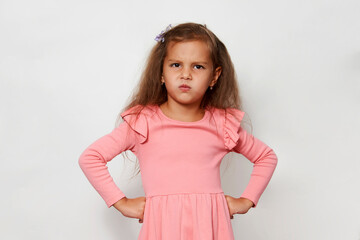 Cute girl posing with hands on hip against white background