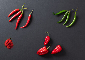 chili peppers on black background