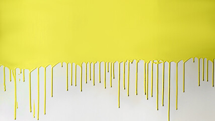 Yellow paint dripping on white wall.