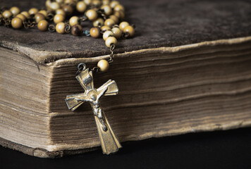 Old Catholic rosary and tattered Bible detail