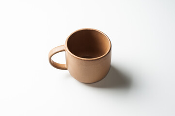 Pottery brown coffee cup isolated on white