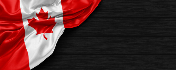 Close Up of Canada flag on the black wooden background 3D render