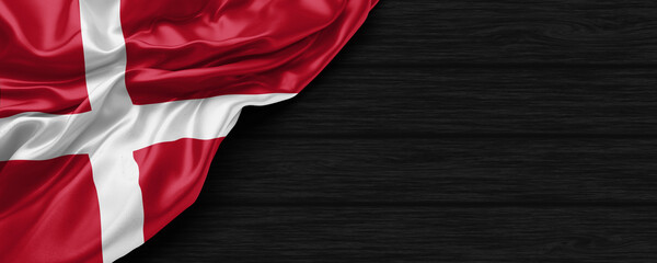 Close Up of Denmark flag on the black wooden background 3D render